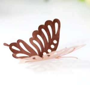 Macro shot of 3D cutout butterfly wall sticker with hollow geometric pattern and reflection