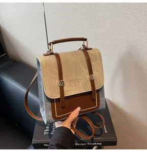 Detail of vintage beige canvas and brown leather stitching with embossed logo
