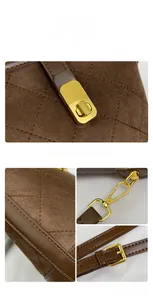 Detailed close-up of dark brown quilted suede bucket bag with gold-tone hardware and stitching