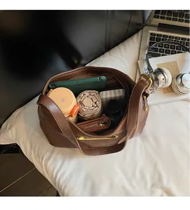 Brown leather handbag interior showing large capacity for tablet, umbrella and wallet