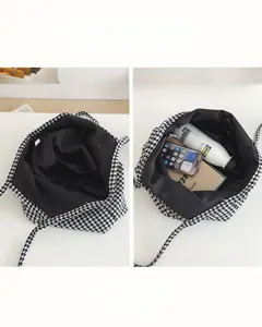 Macro view of the large capacity houndstooth tote bag interior with multiple compartments
