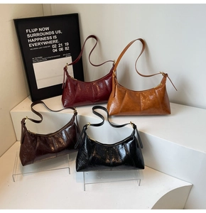 Detailed display of four vintage oil wax leather hobo bags in various autumn colors