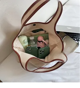 Top view of spacious canvas tote interior showing capacity for laptops and daily essentials