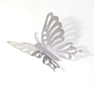 Detailed macro view of silver 3D hollow butterfly wall sticker with metallic finish