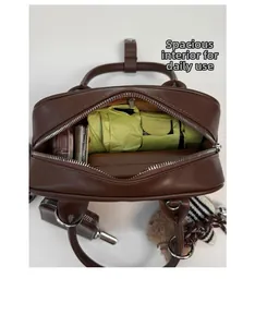 Top view of spacious interior of a brown Boston bag with umbrella and wallet