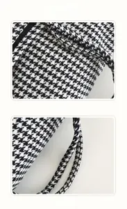 Close-up of houndstooth tote bag fabric texture and comfortable cylindrical handles