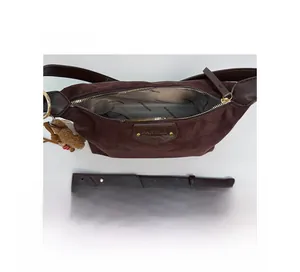 Detail view of spacious brown suede tote interior with multiple pockets and brand lining