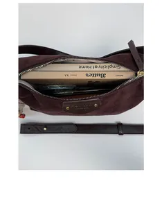 Interior view of vintage matte shoulder bag showing daily capacity for books and phone