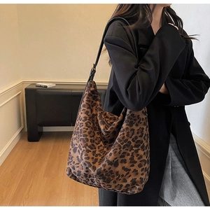 Close-up of leopard print tote bag with soft texture and adjustable black shoulder strap