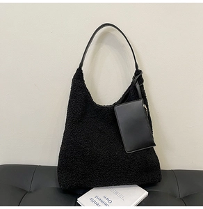 Detail of black fuzzy faux fur tote bag with leather strap and matching card pouch