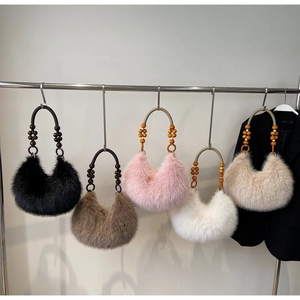 Detailed row of plush faux fur handbags with decorative beaded handles in five colors