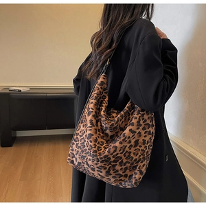 Detailed back view of a large leopard print hobo tote bag on a model for autumn style