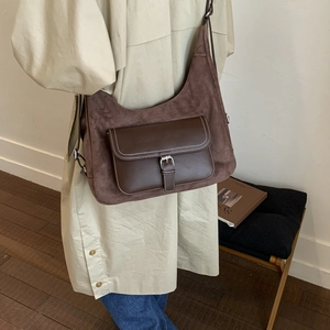 Detail view of large dark brown hobo bag with suede and smooth leather texture contrast