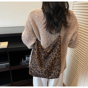 Brown leopard print hobo tote bag shown on model with spacious autumn casual design
