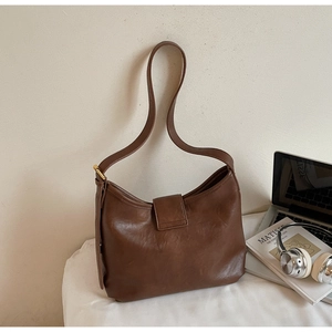 Detail view of the vintage dark brown leather hobo bag with adjustable strap and smooth texture