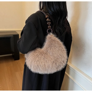 Detailed back view of a fuzzy beige faux fur shoulder bag with vintage wooden bead strap