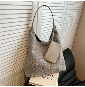 Detail of grey fuzzy sherpa hobo bag with matching leather card holder charm