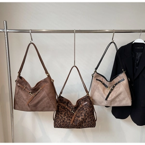 Detailed comparison of large suede tote bags in brown, leopard print, and beige finishes