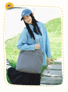 Outdoor lifestyle shot of a large houndstooth tote bag for daily commute or campus use