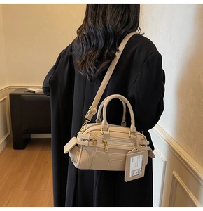 Beige Boston bag side view shown on model for elegant daily commuting style