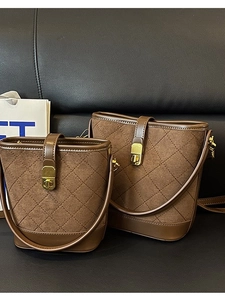 Brown quilted bucket bags in matte suede and leather with gold hardware and strap