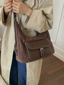 Retro brown suede hobo bag with leather flap pocket, styled with a beige trench coat