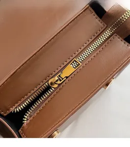 Macro shot of smooth metal zipper and premium brown leather texture on backpack
