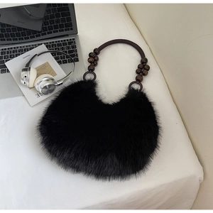 Detail of black faux fur handbag with bohemian wooden bead and woven rope handle