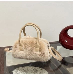 Close-up of fuzzy faux fur texture with smooth leather handle and adjustable shoulder strap