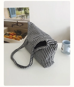 Macro shot of the black and white houndstooth fabric texture on the knit tote bag