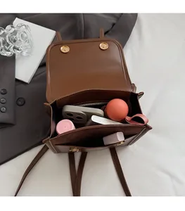 Interior view showing spacious compartments and zip pocket of this brown leather backpack