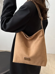 Brown frosted leather tote bag with adjustable strap and metallic buckle for women