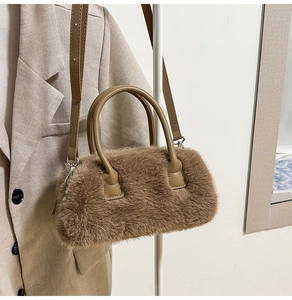 Detail of plush brown faux fur handbag with leather handle and silver metal hardware