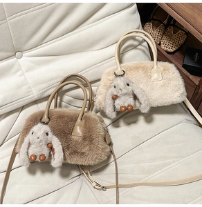 Detail view of fuzzy crossbody bags in cream and coffee with cute rabbit charms