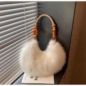 Detail of white faux fur handbag with bohemian wooden bead handle and woven rope