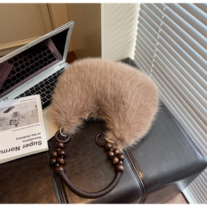 Detail of soft camel faux fur texture on crescent bag with wooden bead strap