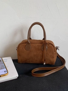 Brown faux suede Boston handbag with leather handles and adjustable shoulder strap