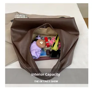 Spacious interior of dark brown leather tote bag showing organized daily essentials