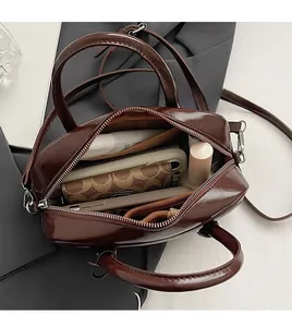 Top view of retro brown crossbody bag showing spacious interior for phone and makeup
