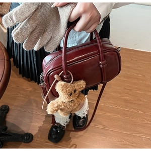 Deep red vintage Boston bag in shiny PU leather with a cute plush bear charm detail