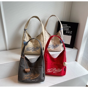 Collection of minimalist canvas tote bags in four colors with embroidered branding