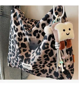 Detail of leopard print shoulder bag with plush toast charm and soft fabric texture
