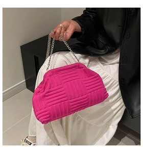 Macro detail of fuchsia woven shell bag with premium 3D texture and silver chain