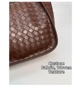 Detail shot of deep brown wide-strip leather weave craftsmanship on this tote bag