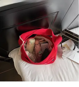 Top-down view of spacious red canvas tote bag showing large capacity for daily essentials