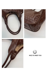 Detailed close-up of dark brown woven leather texture and handle stitching on tote bag