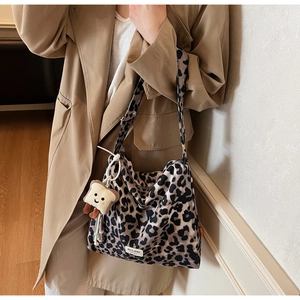 Detail of leopard print canvas bag featuring MULAIDI logo and plush toast charm