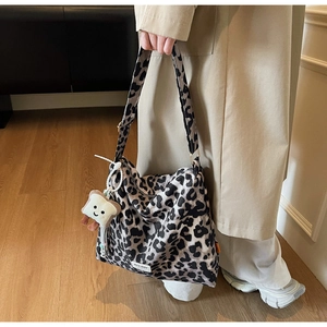 Detailed view of leopard print tote bag with a cute toast plush pendant and logo tag