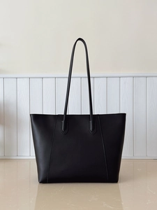 Detail view of large black tote bag featuring matte faux leather and minimalist design