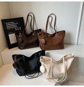 Detailed view of four colorful PU leather tote bags with matching small round pendants